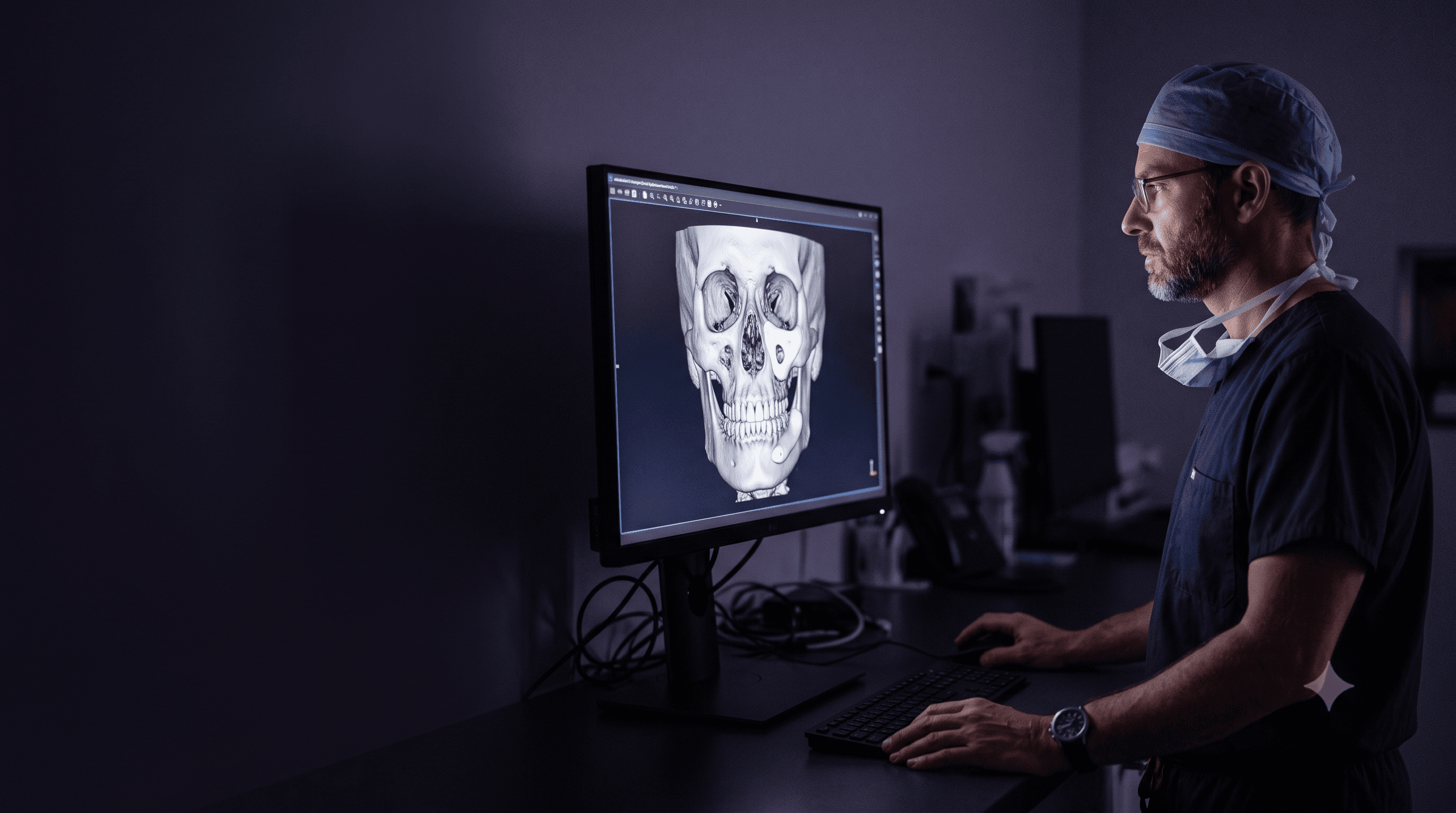 Surgeon reviewing the digital design of a facial prosthesis over the patient's CT scan